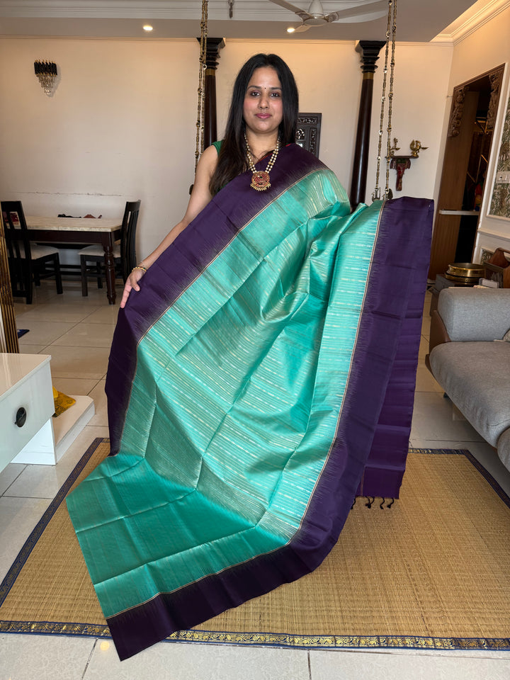 Pastel Light Blue with Purple , rich zari gold and silver zari butta in the body and grand  Pallu , pure soft silk saree