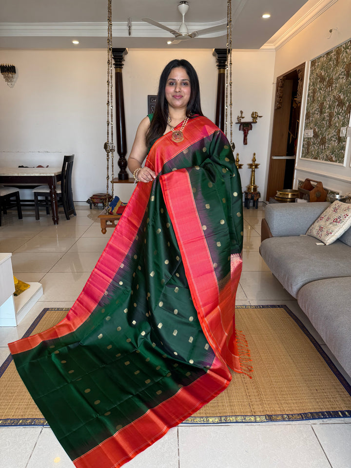 Dark Green with Pinkish Orange , rich zari annam and rudraksh butta in the body , vairaoosi borders and rich Pallu , pure soft silk saree