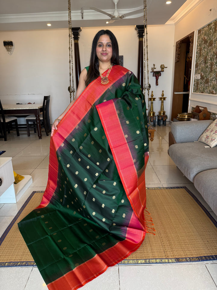 Dark Green with Pinkish Orange , rich zari annam and rudraksh butta in the body , vairaoosi borders and rich Pallu , pure soft silk saree
