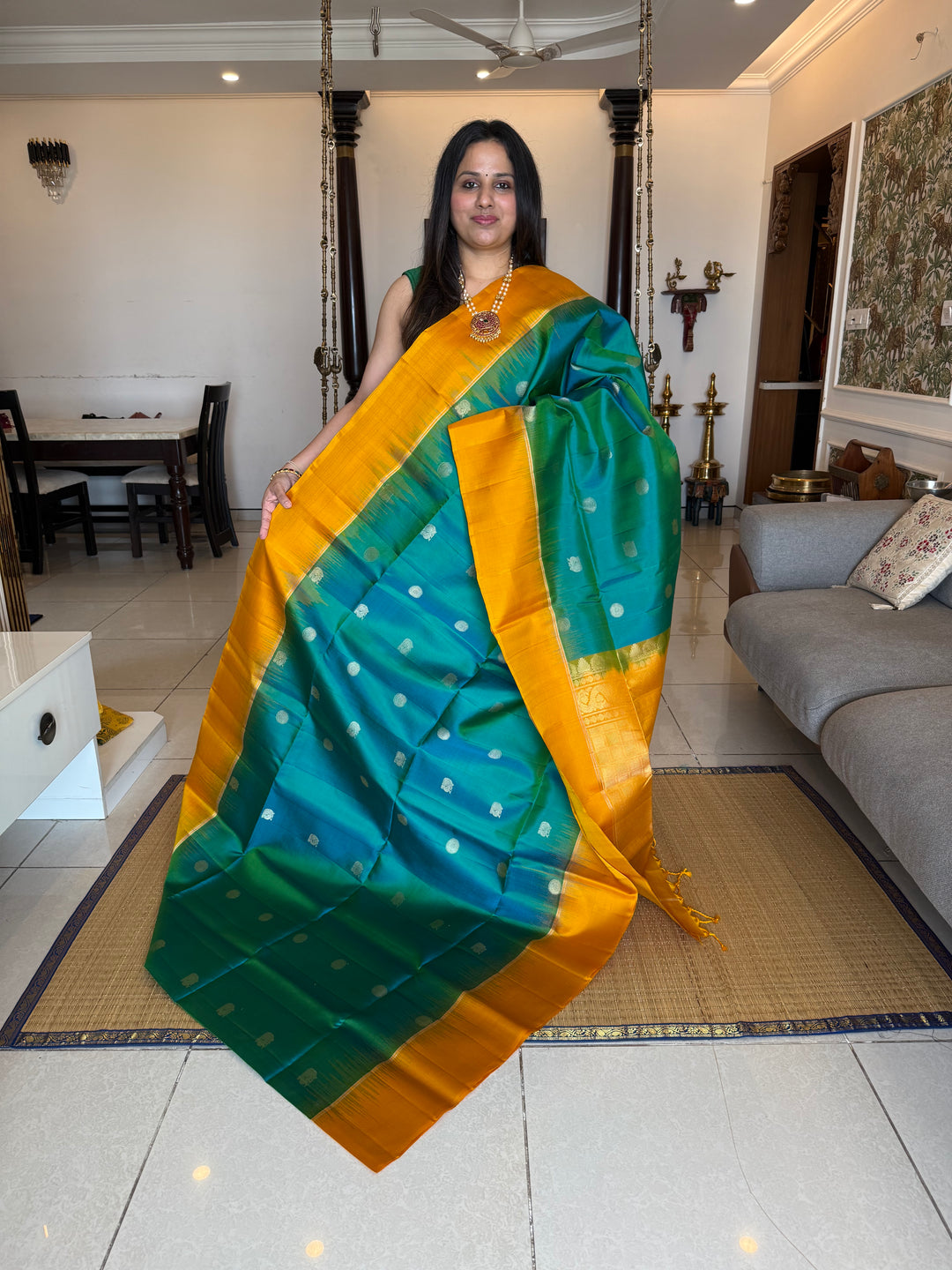 Greenish Blue with Manjal , rich zari rudraksh butta in the body , plain borders and rich Pallu , pure soft silk saree