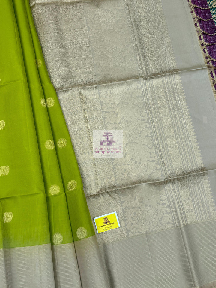Pastel Green with Beige , Zari lines in the border , Annam and Chakram butta in the body and rich Pallu Pure Soft Silk Saree