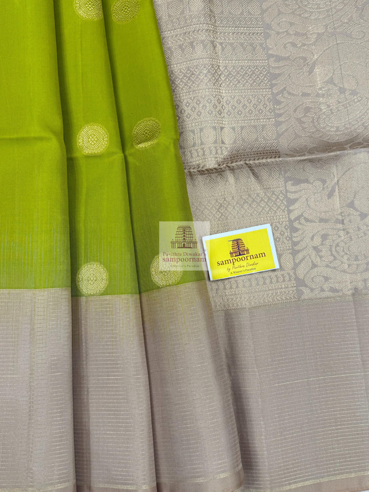 Pastel Green with Beige , Zari lines in the border , Annam and Chakram butta in the body and rich Pallu Pure Soft Silk Saree