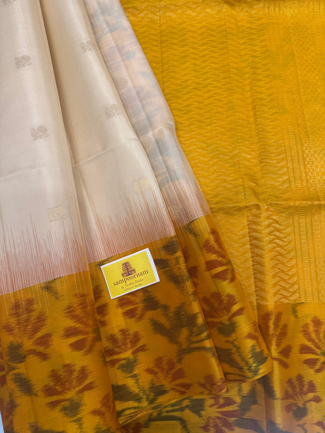 Offwhite with Yellow , Pochampally borders and blouse , Zari Mayil butta in the body and rich Pallu , pure soft silk saree