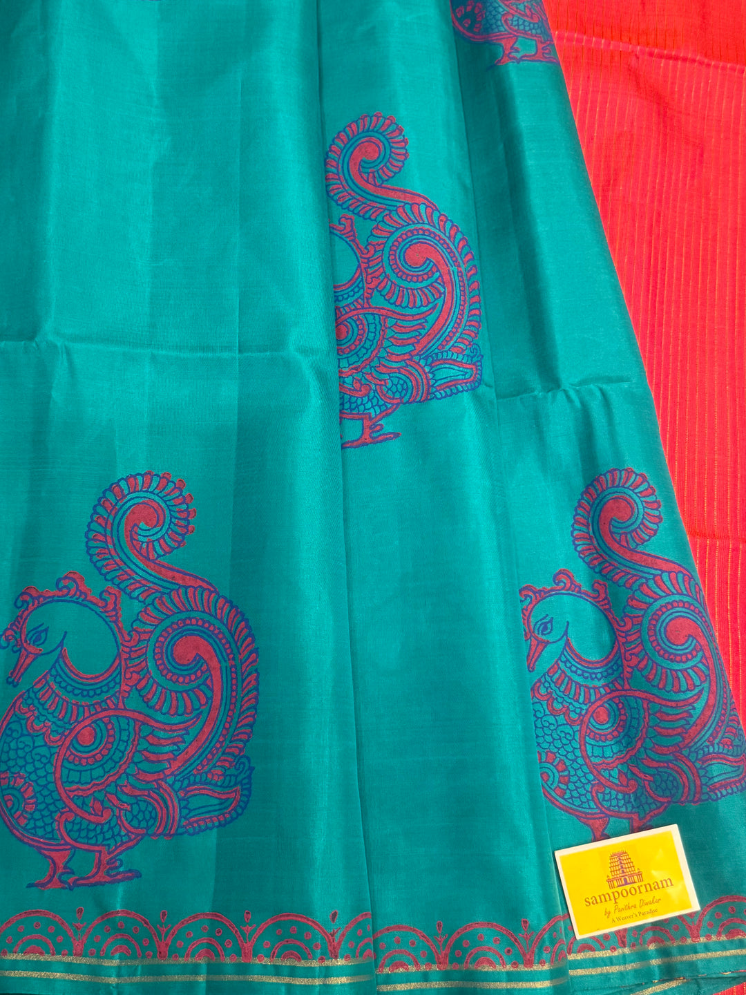 Light Blue with Orangish Pink , annam Handblock print in the body , simple zari lines in the Pallu and Blouse, pure soft silk saree