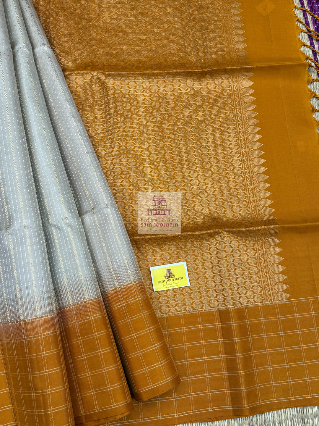 Mustard with Beige , Zari checks in the border , Vertical Gold and Silver lines in the body and rich Pallu Pure Soft Silk Saree