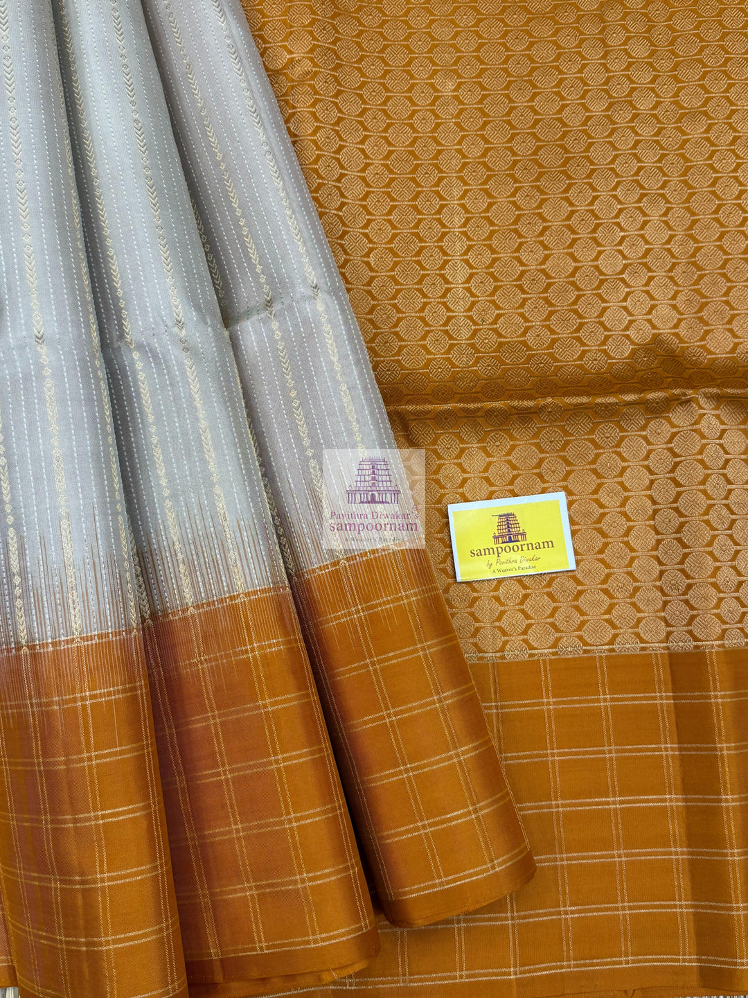 Mustard with Beige , Zari checks in the border , Vertical Gold and Silver lines in the body and rich Pallu Pure Soft Silk Saree