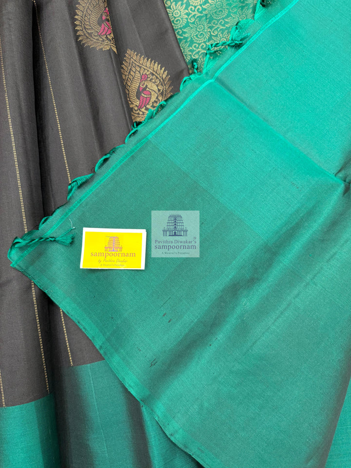 Black with Green , rich Zari butta in the body , rettapet border and grand  Pallu Pure Soft Silk Saree