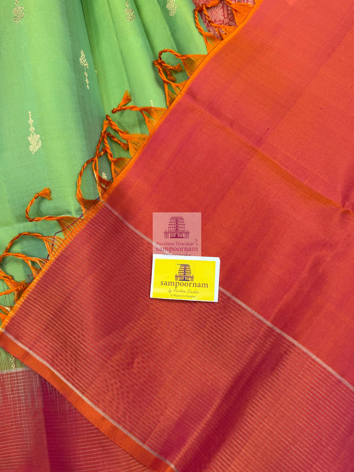 Pastel Green with Orangish Pink , Vairaoosi lines in the border , rich butta in the body Mambazha Manjal with Black , one side big border , rich Zari butta in the body and grand  Pallu Pure Soft Silk Saree
