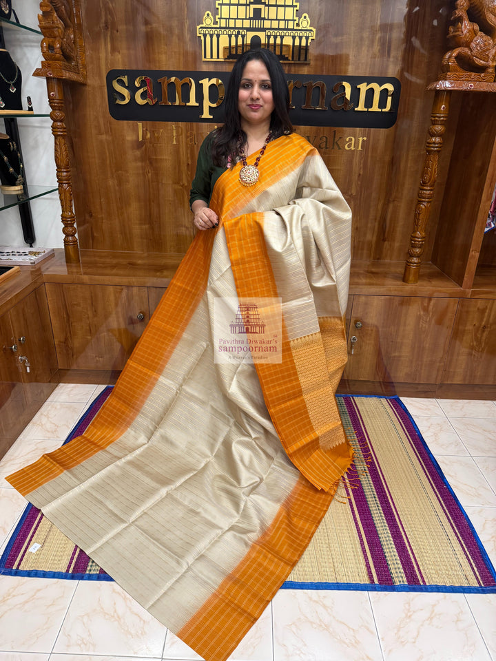 Mustard with Beige , Zari checks in the border , Vertical Gold and Silver lines in the body and rich Pallu Pure Soft Silk Saree