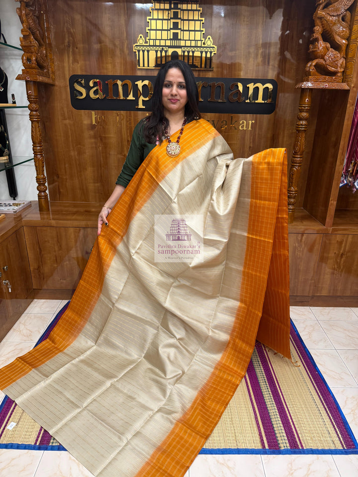 Mustard with Beige , Zari checks in the border , Vertical Gold and Silver lines in the body and rich Pallu Pure Soft Silk Saree