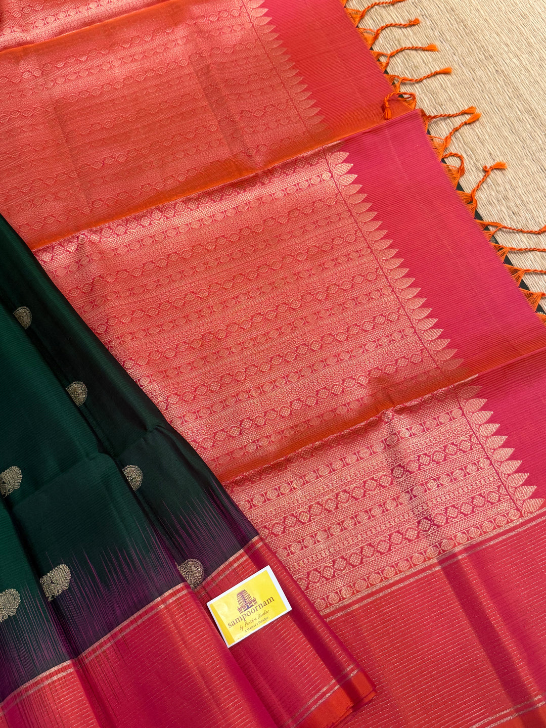 Dark Green with Pinkish Orange , rich zari annam and rudraksh butta in the body , vairaoosi borders and rich Pallu , pure soft silk saree