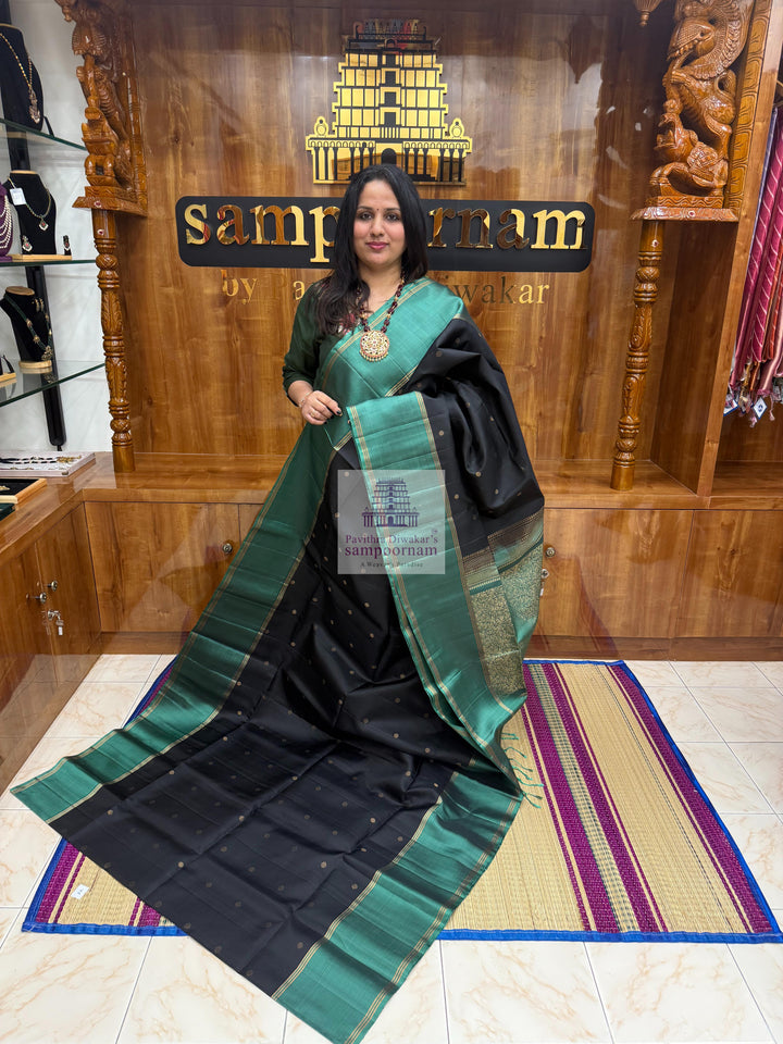Black with Sage Green , Vairaoosi lines in the border , Floral Zari butta in the body and grand  Pallu Pure Soft Silk Saree