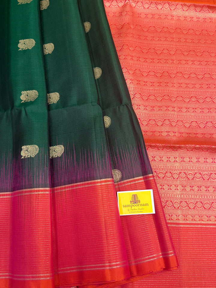 Dark Green with Pinkish Orange , rich zari annam and rudraksh butta in the body , vairaoosi borders and rich Pallu , pure soft silk saree