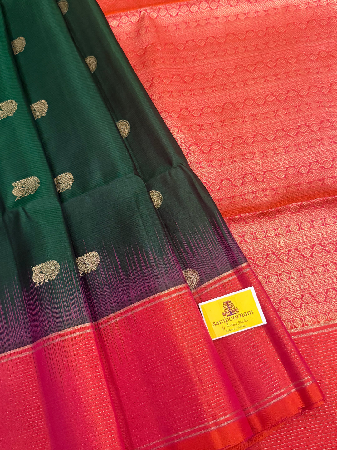 Dark Green with Pinkish Orange , rich zari annam and rudraksh butta in the body , vairaoosi borders and rich Pallu , pure soft silk saree