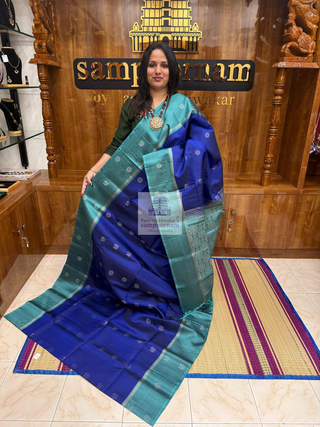 Dark Blue with Teel Blue ,  Zari lines in the border , Annam and Chakram butta in the body and rich Pallu Pure Soft Silk Saree