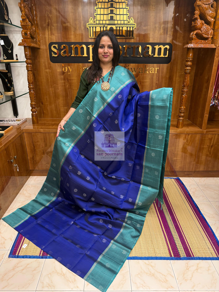 Dark Blue with Teel Blue ,  Zari lines in the border , Annam and Chakram butta in the body and rich Pallu Pure Soft Silk Saree