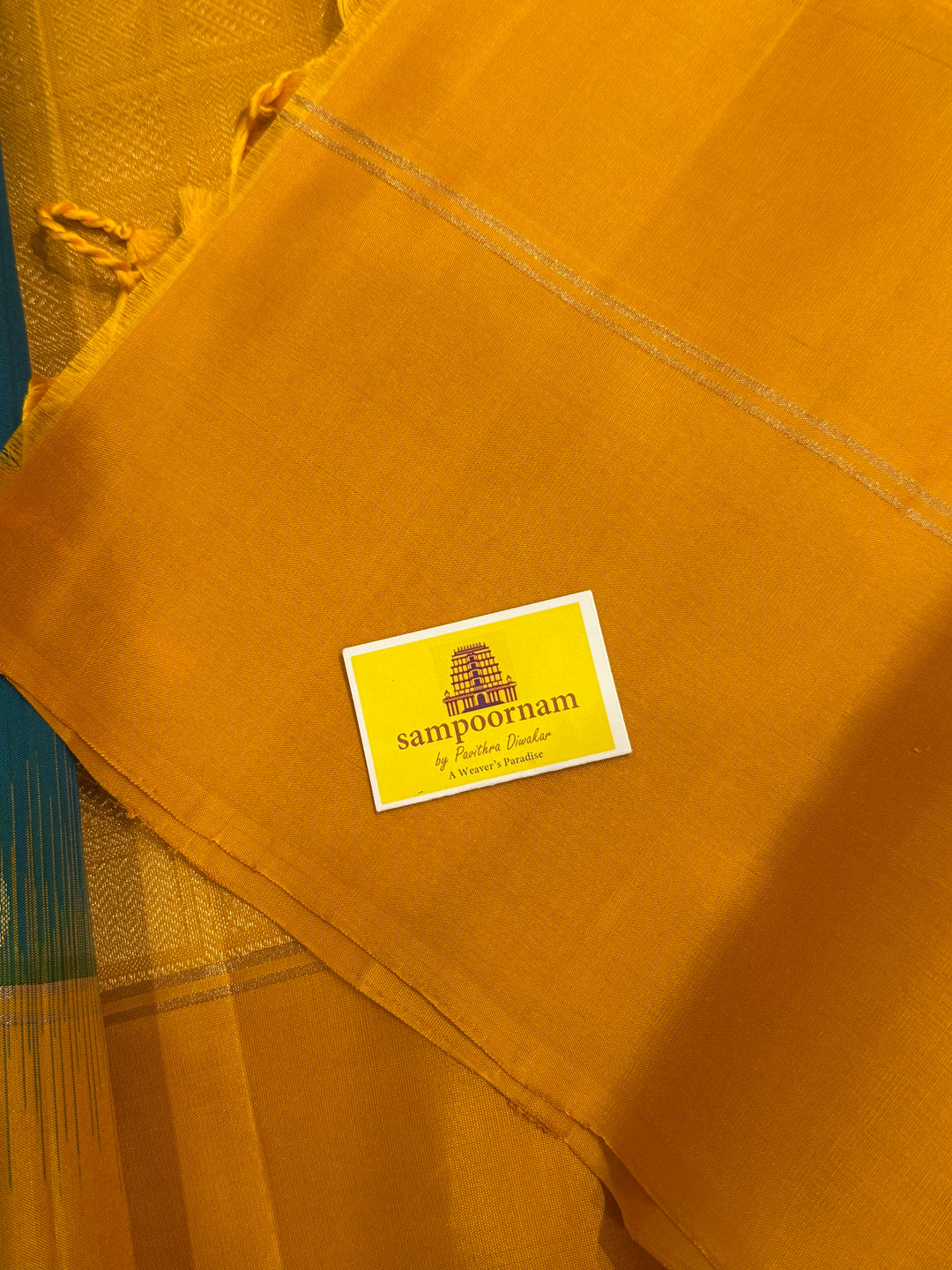 Greenish Blue with Manjal , rich zari rudraksh butta in the body , plain borders and rich Pallu , pure soft silk saree