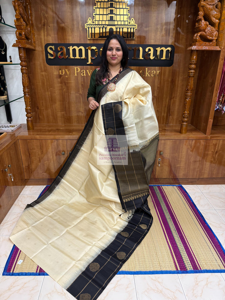 Offwhite with Black , one side big border , Vairaoosi lines and rich Zari butta in the body and grand  Pallu Pure Soft Silk Saree
