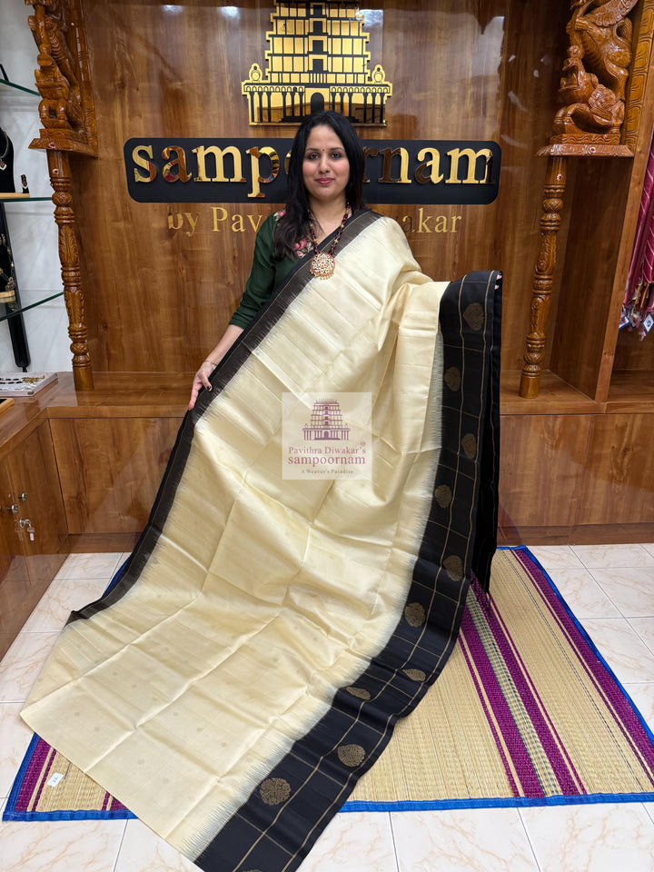 Offwhite with Black , one side big border , Vairaoosi lines and rich Zari butta in the body and grand  Pallu Pure Soft Silk Saree
