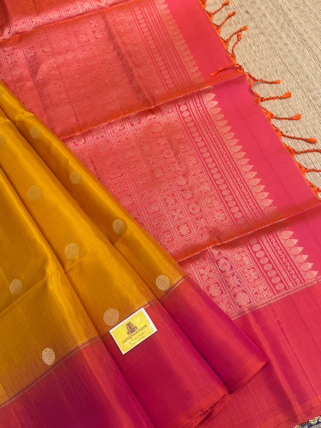 Manjal with Reddish Pink , rich zari checks in the body , vairaoosi lines in the border and rich Pallu , pure soft silk saree