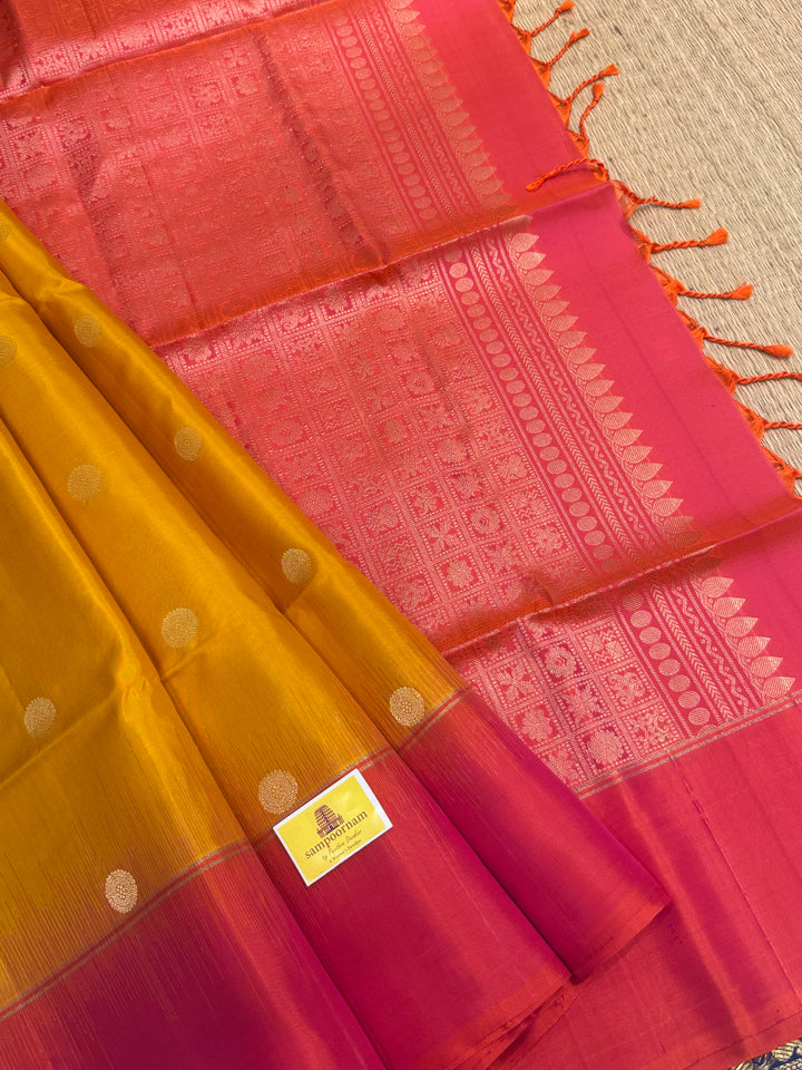 Manjal with Reddish Pink , rich zari checks in the body , vairaoosi lines in the border and rich Pallu , pure soft silk saree