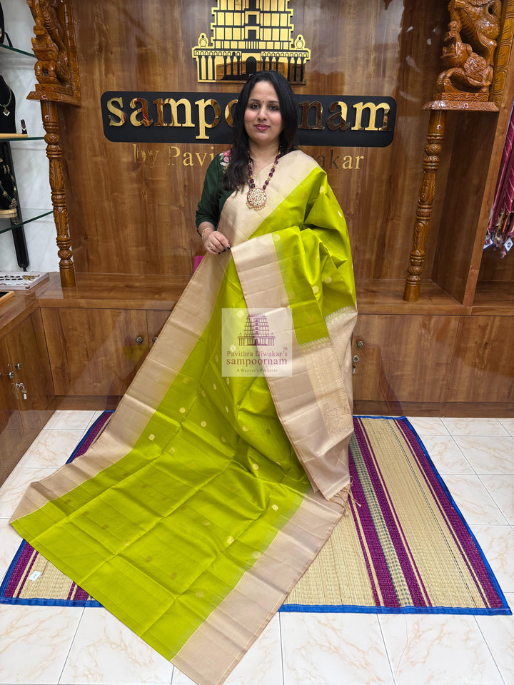 Pastel Green with Beige , Zari lines in the border , Annam and Chakram butta in the body and rich Pallu Pure Soft Silk Saree