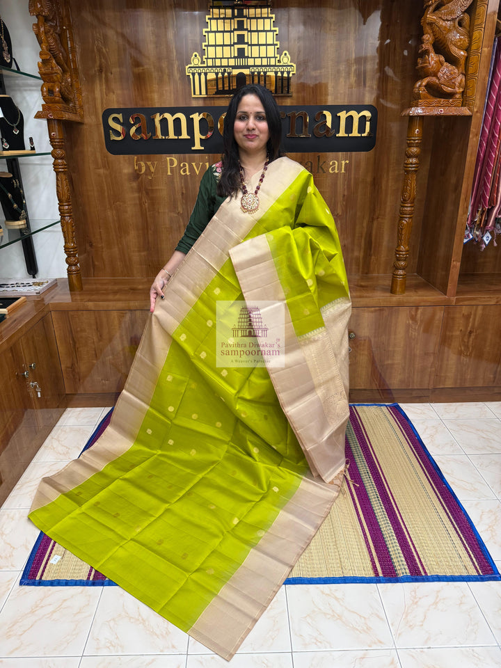 Pastel Green with Beige , Zari lines in the border , Annam and Chakram butta in the body and rich Pallu Pure Soft Silk Saree