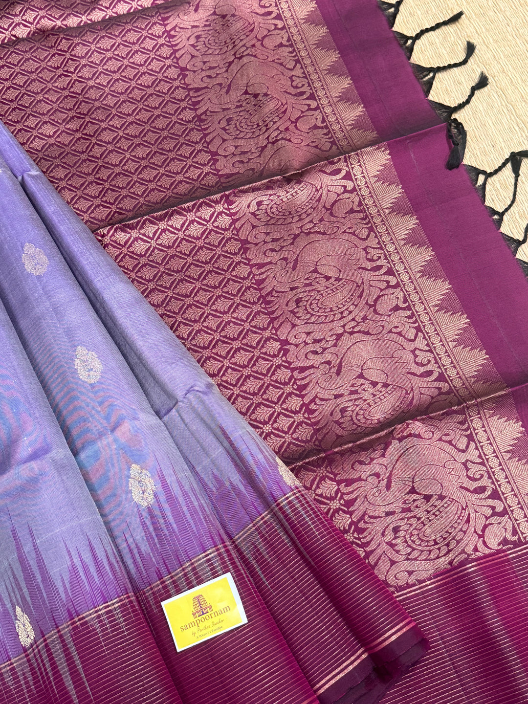 Lavender with Dark Maroon , rich zari butta in the body , vairaoosi lines in the border and rich Pallu , pure soft silk saree