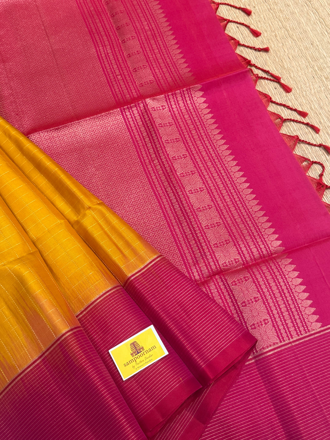 Manjal with Orangish Pink , rich zari annam and rudraksh butta in the body , plain borders and rich Pallu , pure soft silk saree
