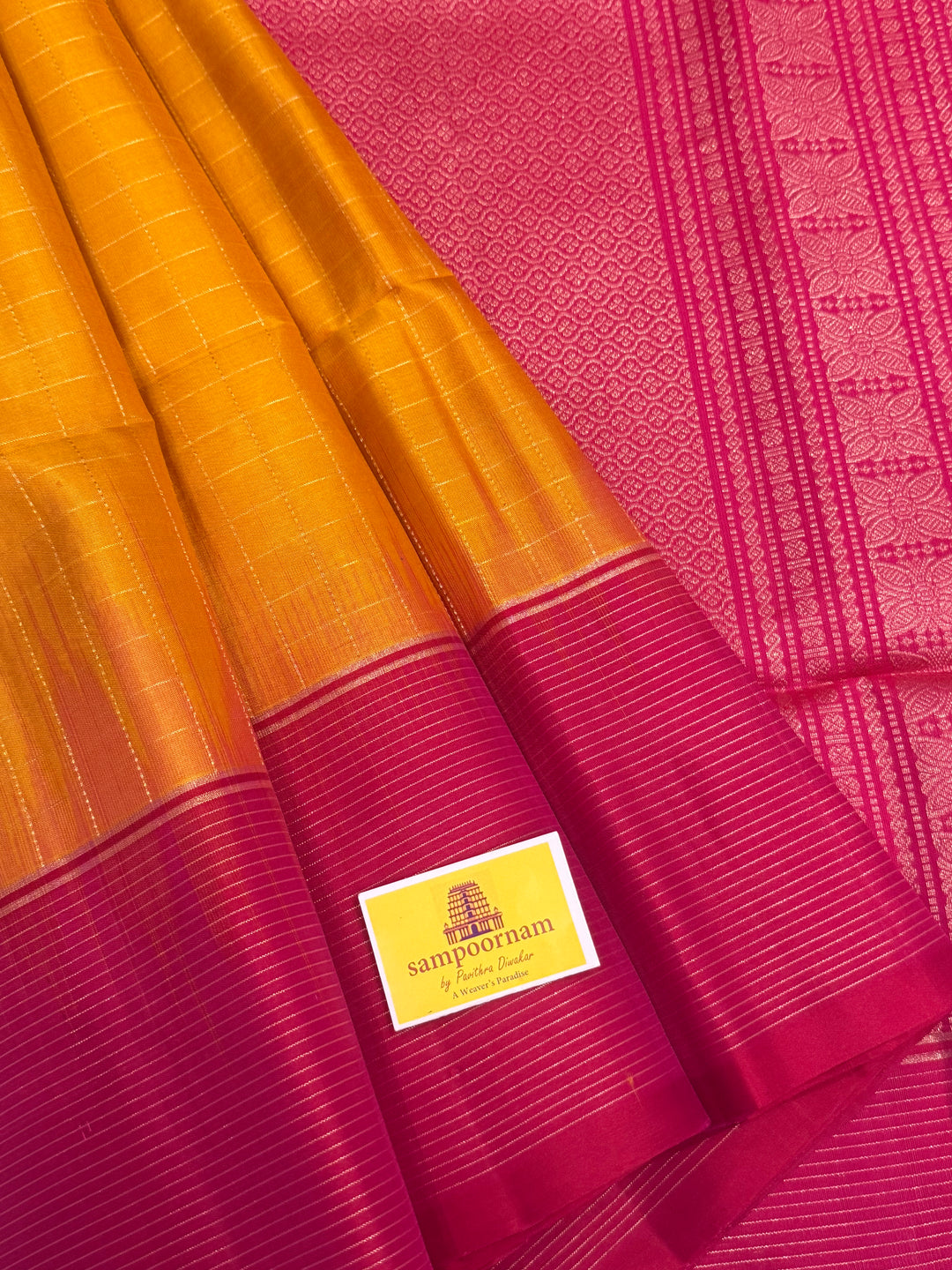 Manjal with Orangish Pink , rich zari annam and rudraksh butta in the body , plain borders and rich Pallu , pure soft silk saree
