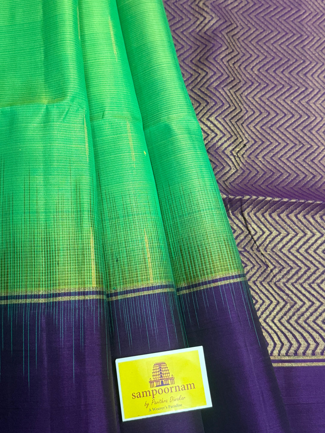 Parrot Green with purple , zari raindrop motif in the body , plain borders and rich Pallu , pure soft silk saree
