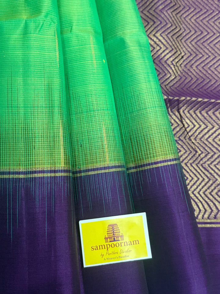 Parrot Green with purple , zari raindrop motif in the body , plain borders and rich Pallu , pure soft silk saree
