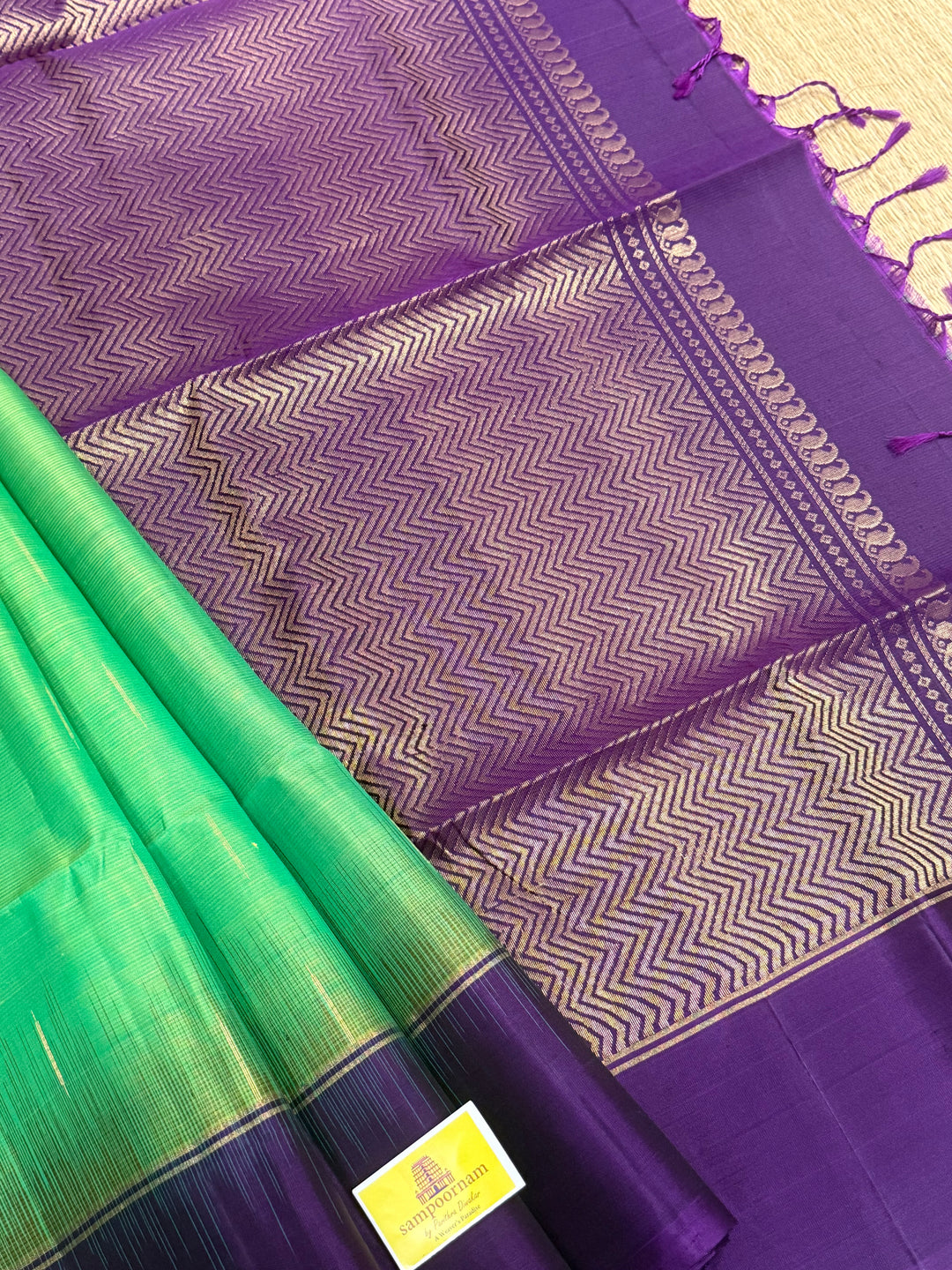 Parrot Green with purple , zari raindrop motif in the body , plain borders and rich Pallu , pure soft silk saree