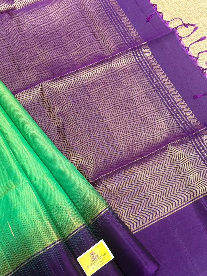 Parrot Green with purple , zari raindrop motif in the body , plain borders and rich Pallu , pure soft silk saree