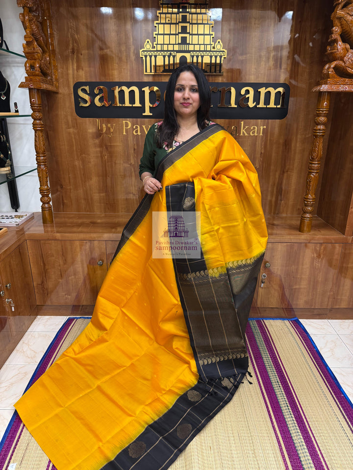 Mambazha Manjal with Black , one side big border , rich Zari butta in the body and grand  Pallu Pure Soft Silk Saree