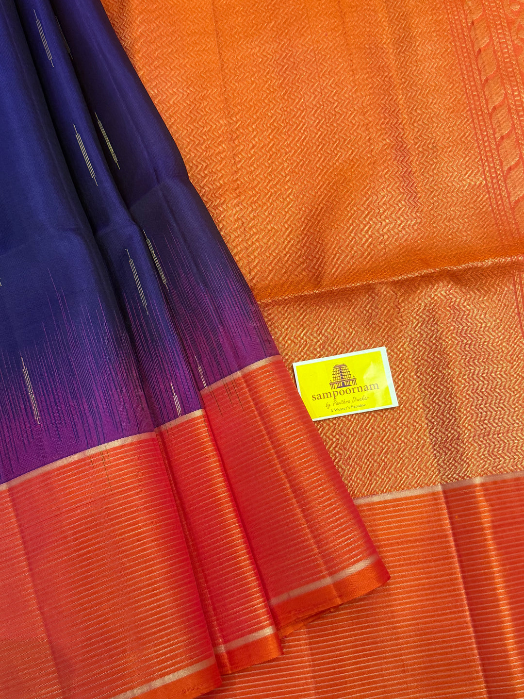 Indigo Blue with Orangish Pink raindrop zari motif in the body , vairaoosi borders and rich Pallu , pure soft silk saree