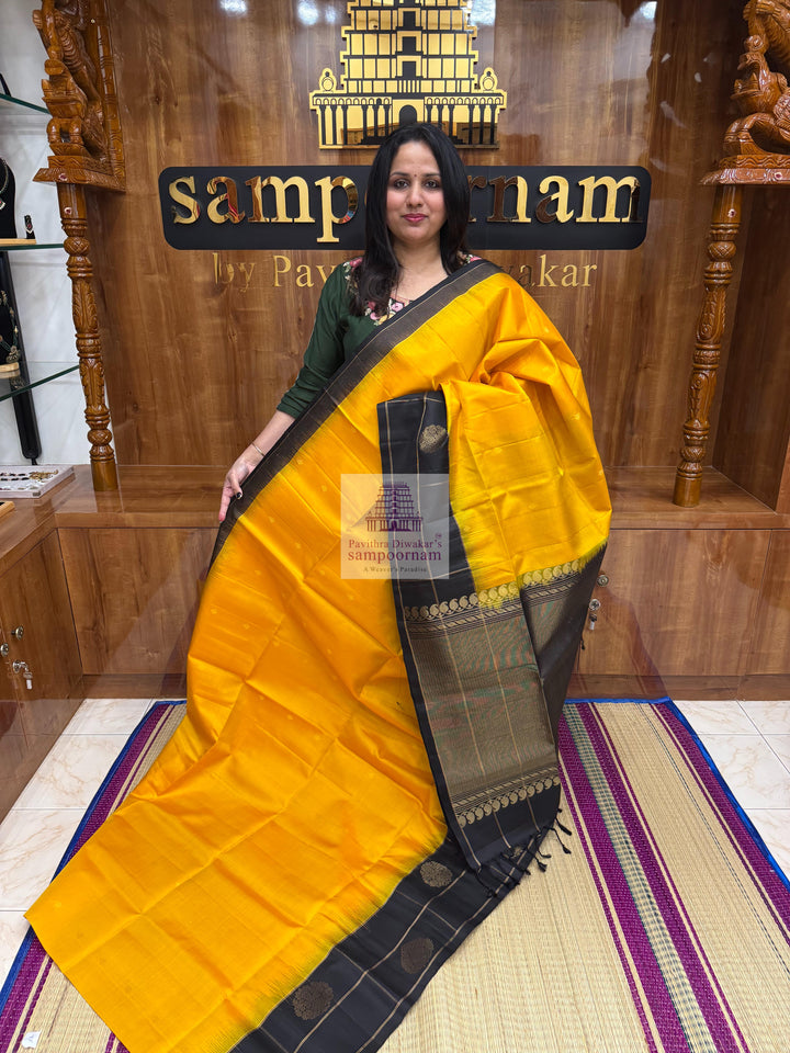 Mambazha Manjal with Black , one side big border , rich Zari butta in the body and grand  Pallu Pure Soft Silk Saree
