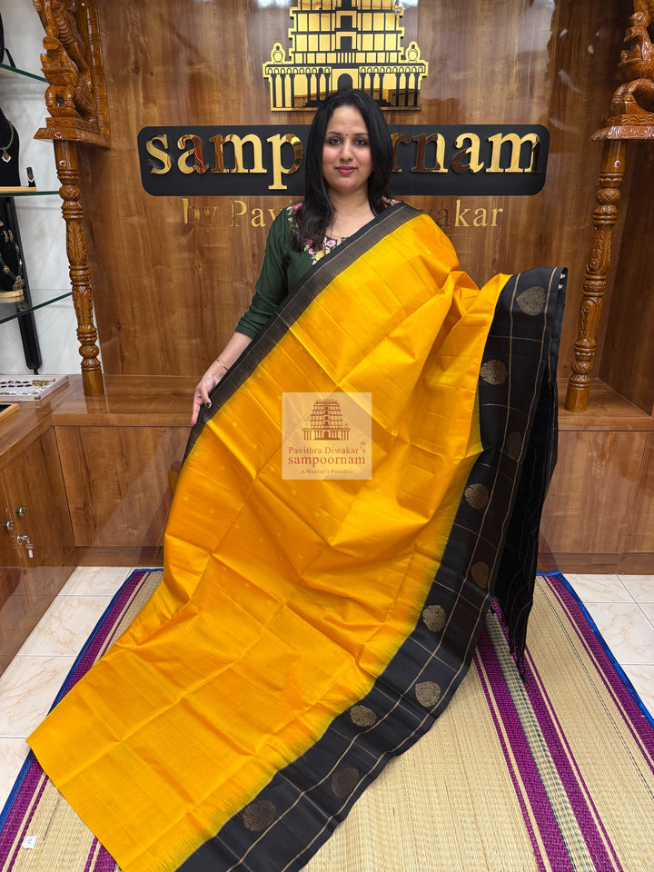 Mambazha Manjal with Black , one side big border , rich Zari butta in the body and grand  Pallu Pure Soft Silk Saree