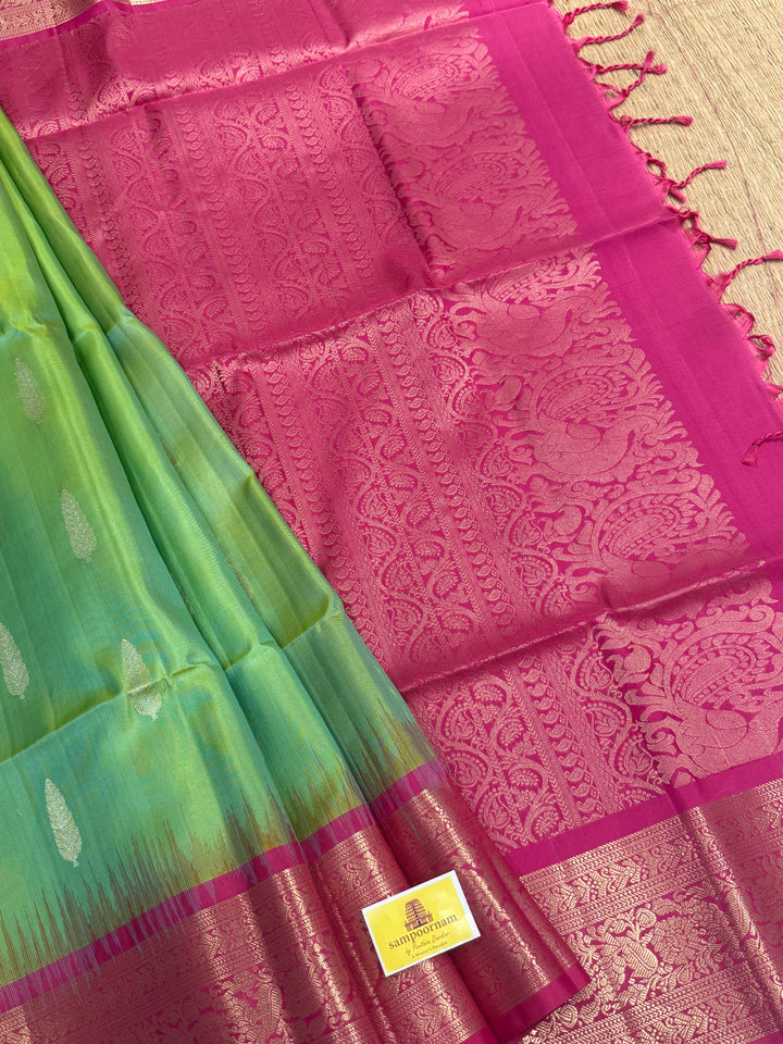 Pastel Green with Pink with rich leaf zari motif in the body , kanchi borders and rich Pallu , pure soft silk saree