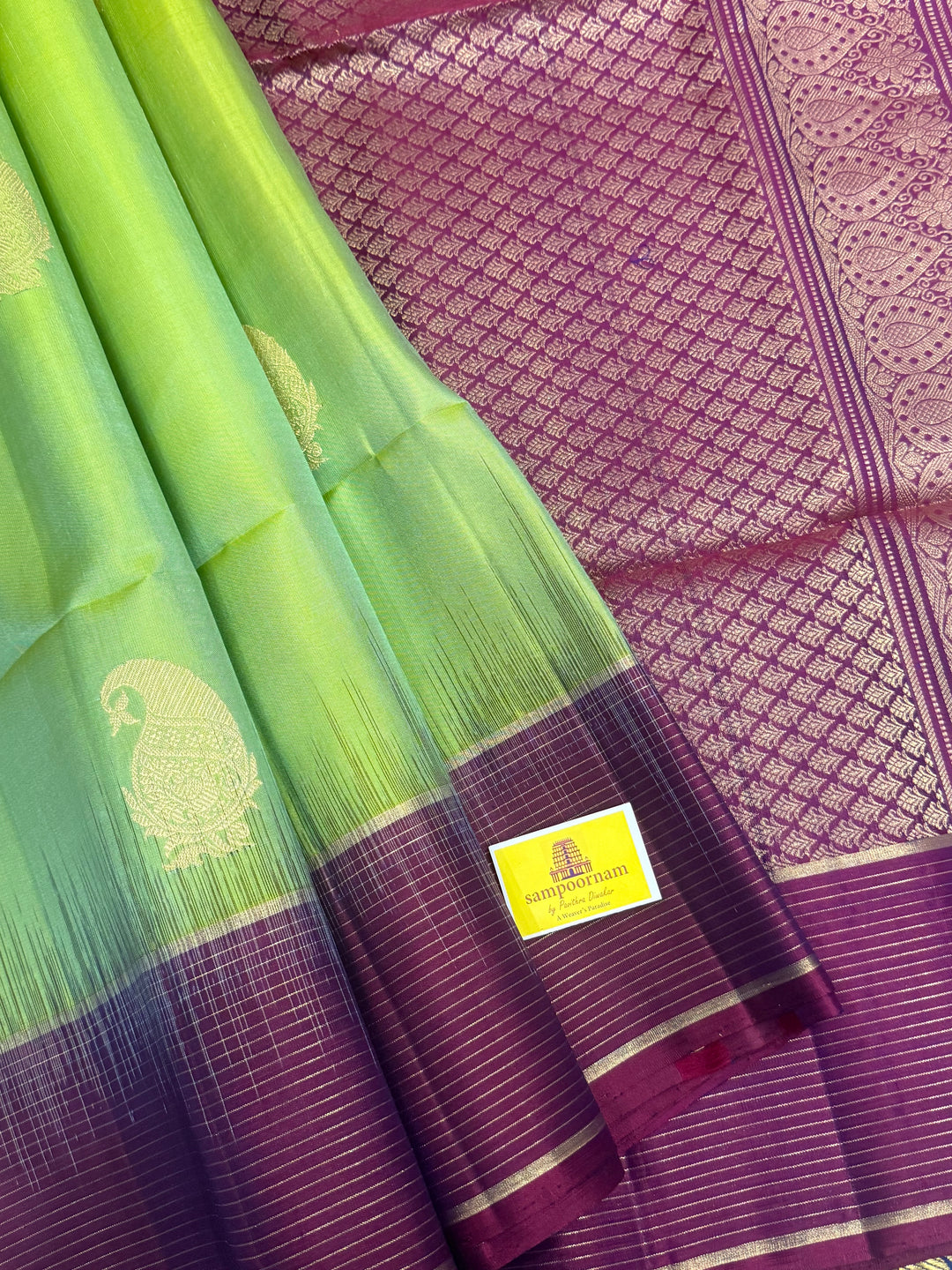 Pastel Green with Purple , rich mango Zari butta in the body , vairaoosi lines in the border and grand  Pallu , pure soft silk saree