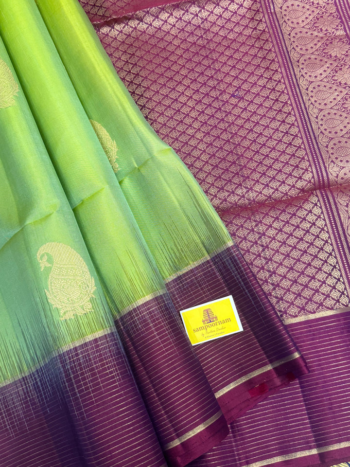 Pastel Green with Purple , rich mango Zari butta in the body , vairaoosi lines in the border and grand  Pallu , pure soft silk saree