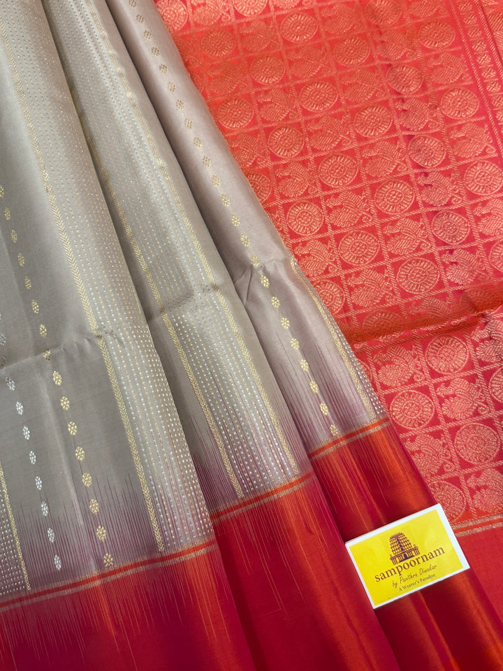 Offwhite with Orangish Pink , rich silver and gold Zari butta in the body , grand Pallu  pure soft silk saree