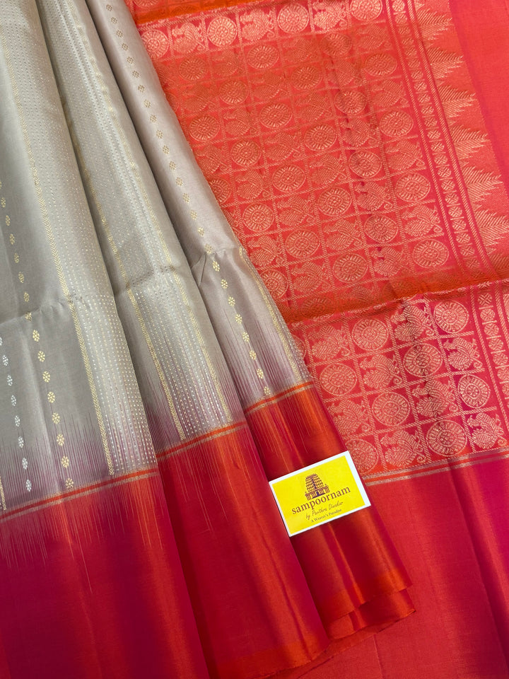 Offwhite with Orangish Pink , rich silver and gold Zari butta in the body , grand Pallu  pure soft silk saree