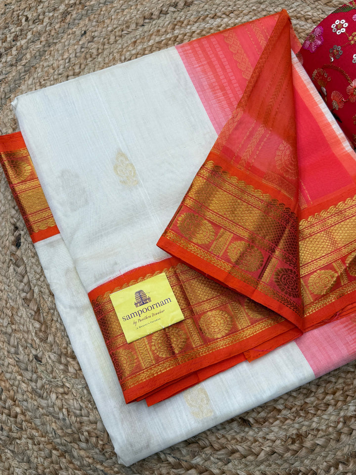 Offwhite with Orange , rich Floral Zari butta in the body and Traditional Borders , rich Pallu Korvai Silk Cotton Saree