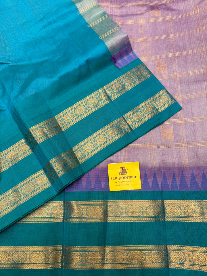 Lilac with Turquoise Blue , Zari Checks with Mayil and Chakram rich Butta  in the body and rettapet border , rich Pallu Korvai Silk Cotton Saree