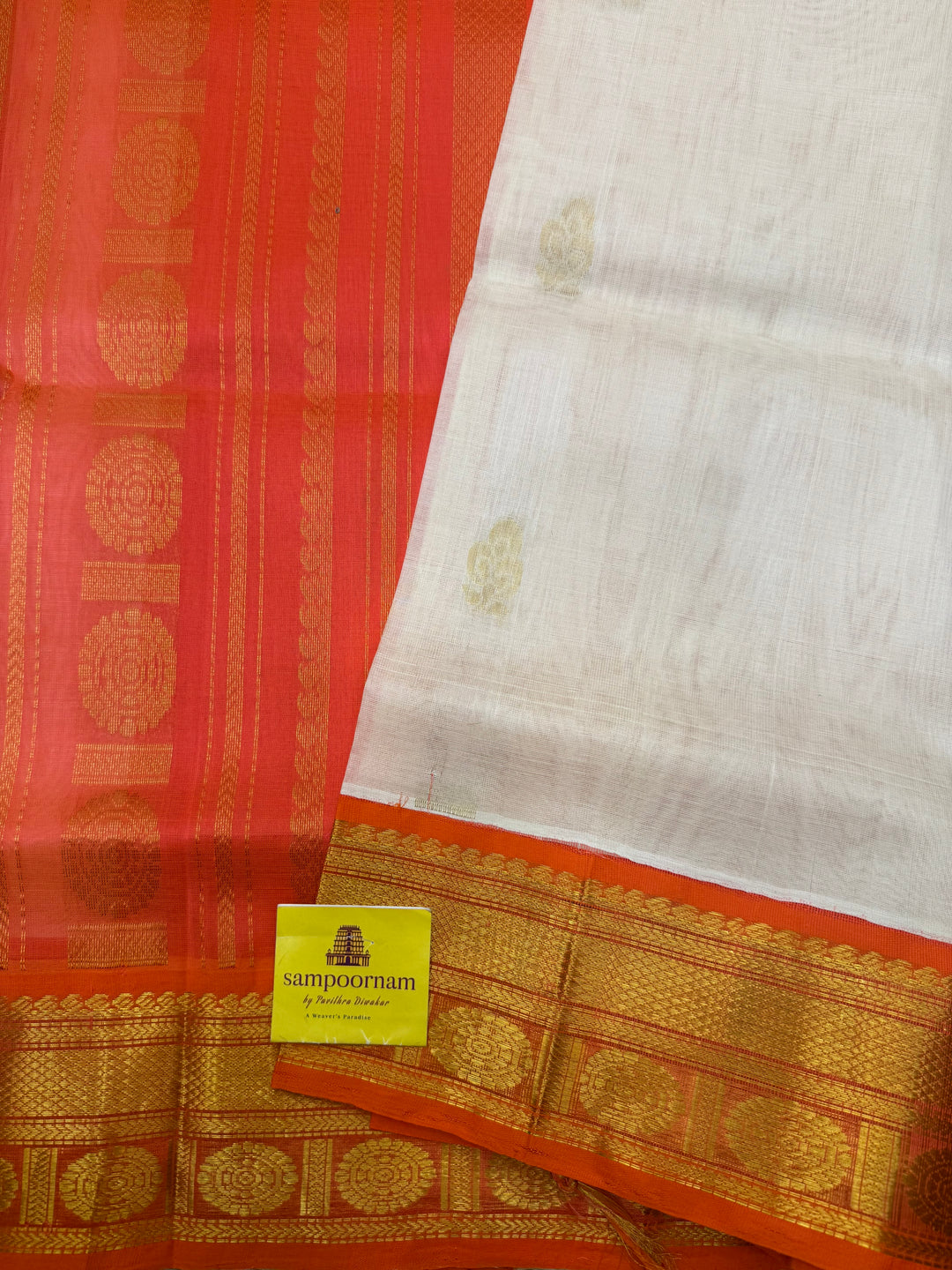 Offwhite with Orange , rich Floral Zari butta in the body and Traditional Borders , rich Pallu Korvai Silk Cotton Saree