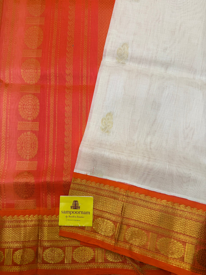 Offwhite with Orange , rich Floral Zari butta in the body and Traditional Borders , rich Pallu Korvai Silk Cotton Saree