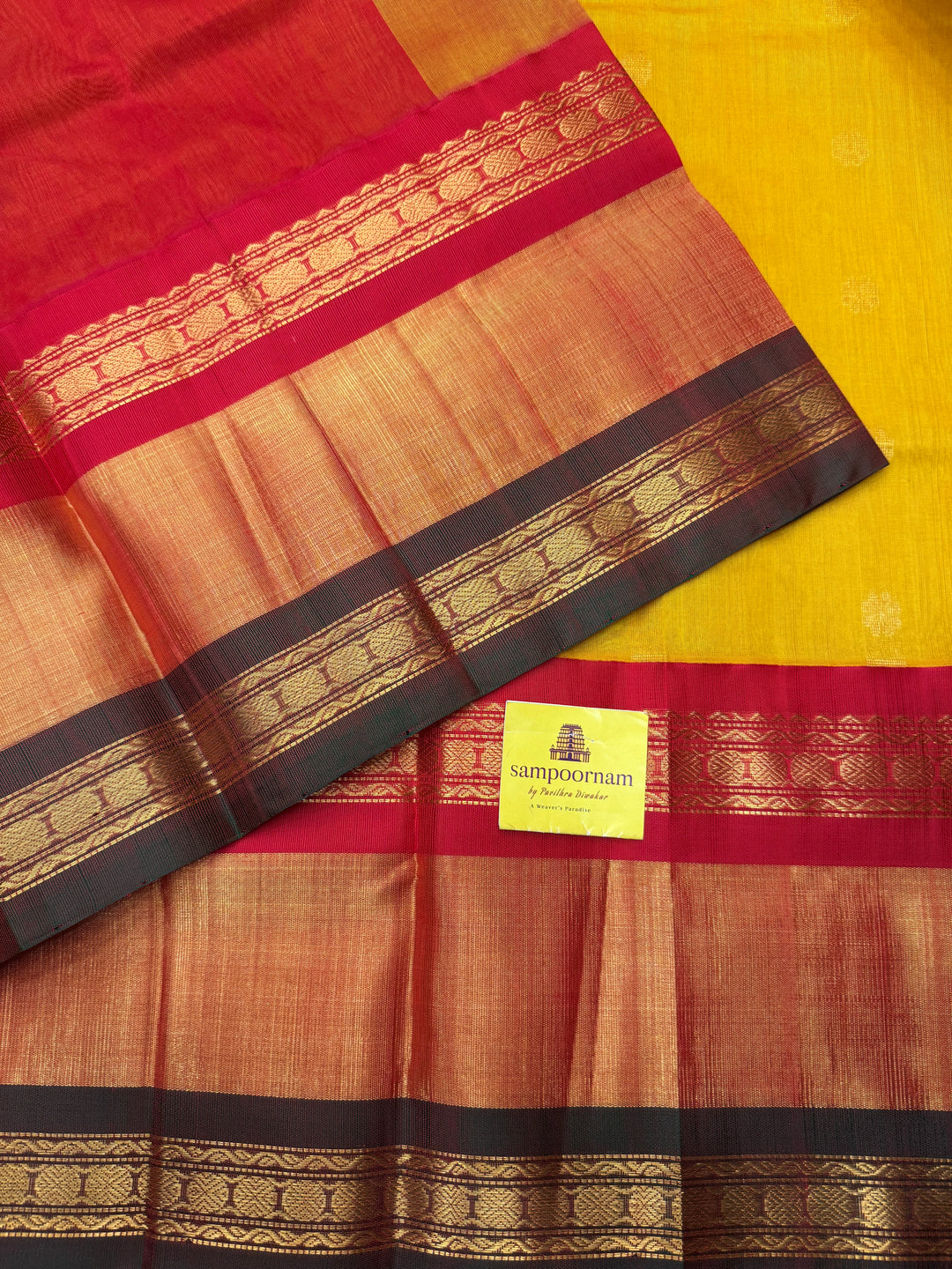 Manjal with Red , rich Floral Zari butta in the body  and One side Triple  Borders , rich Pallu Korvai Silk Cotton Saree