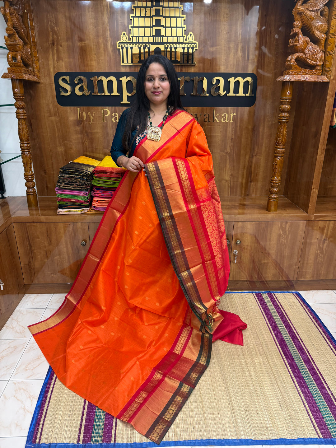 Rust Orange with Red  , rich Floral Zari butta in the body  and One side Triple  Borders , rich Pallu Korvai Silk Cotton Saree