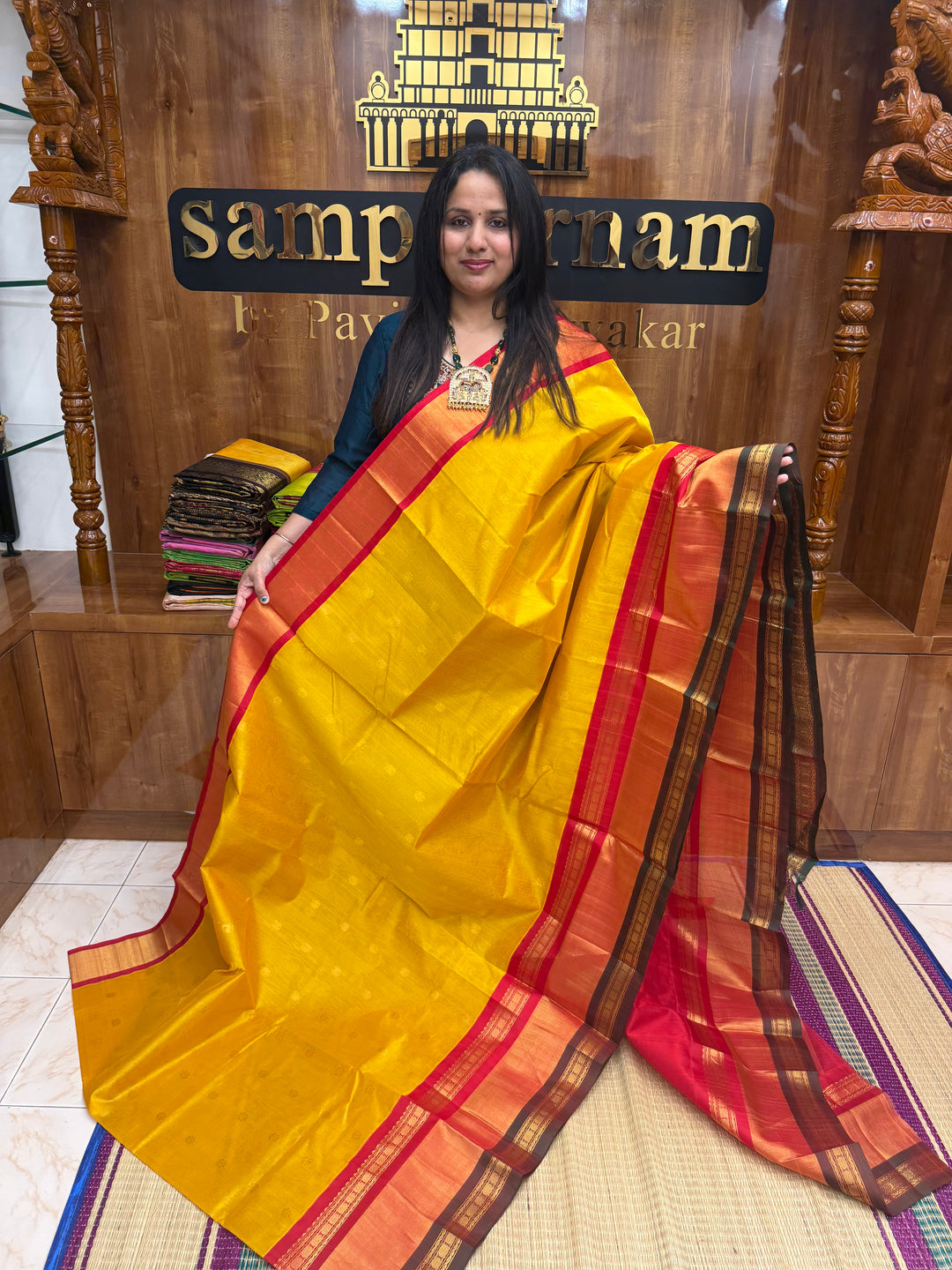 Manjal with Red , rich Floral Zari butta in the body  and One side Triple  Borders , rich Pallu Korvai Silk Cotton Saree